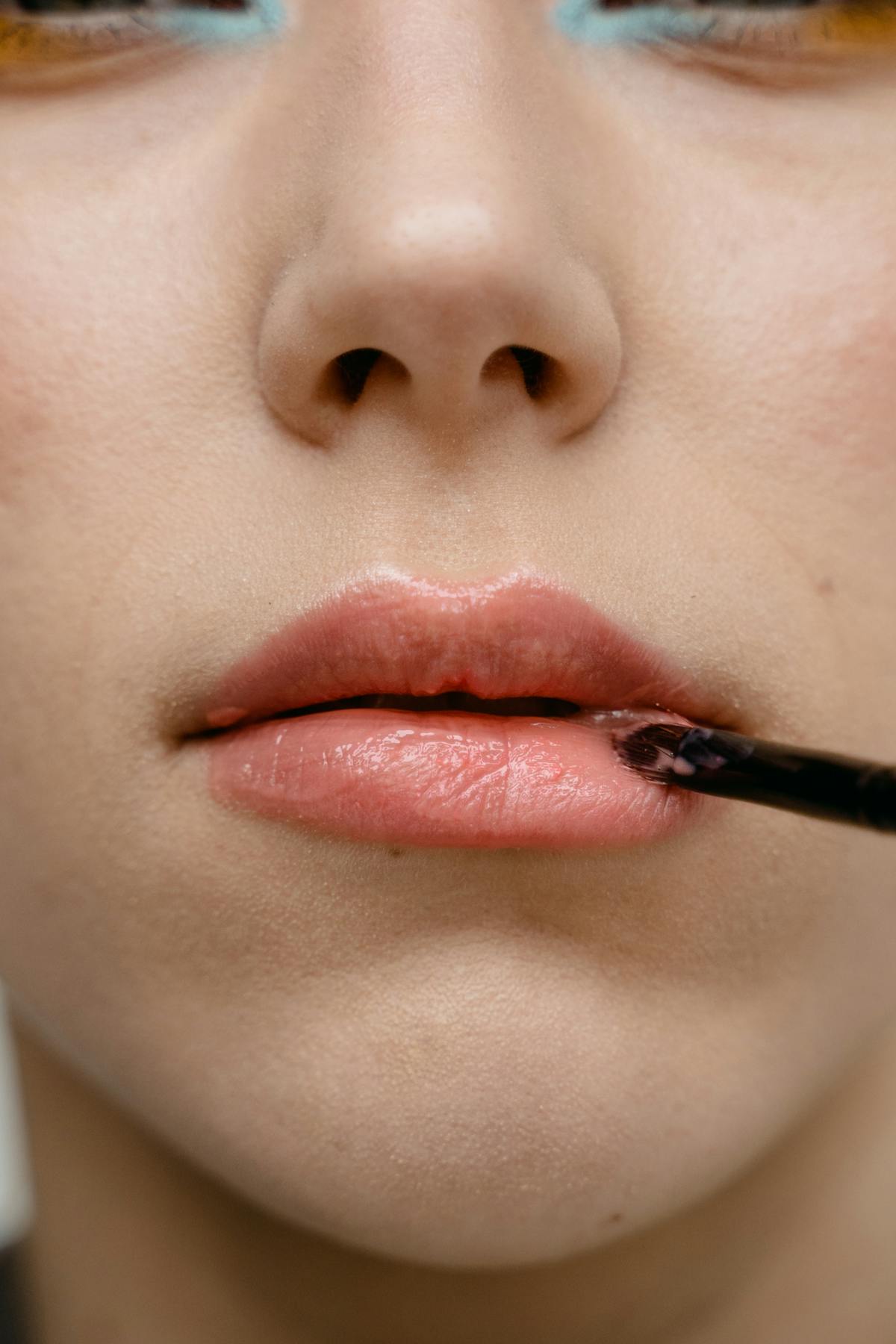 Applying lipstick lip tattoo touch-up closeup