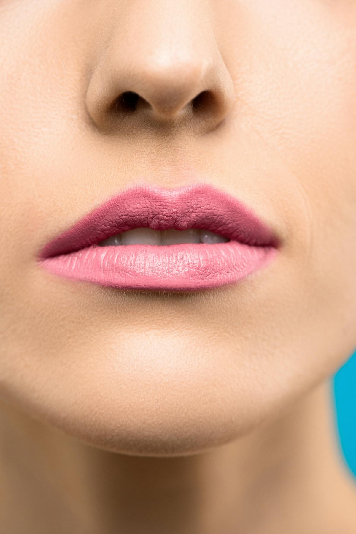 Woman with pink lipstick full lip tattoo color