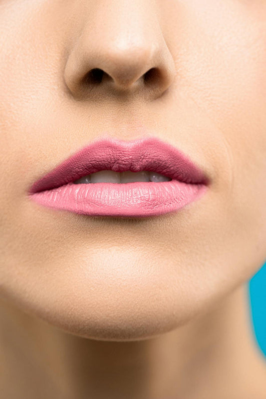 Woman with pink lipstick full lip tattoo color