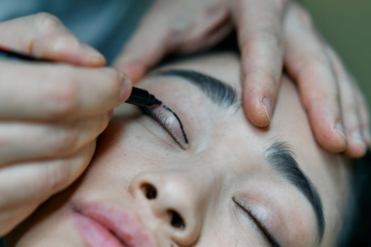Designer eyeliner tattoo cosmetician applying makeup